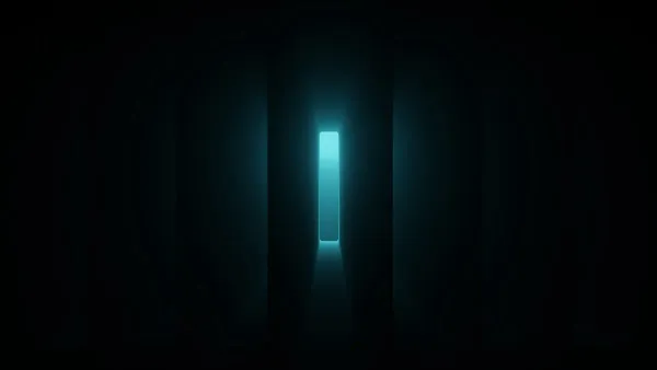 a dark room with a light at the end