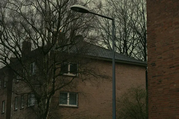 a street light next to a brick building