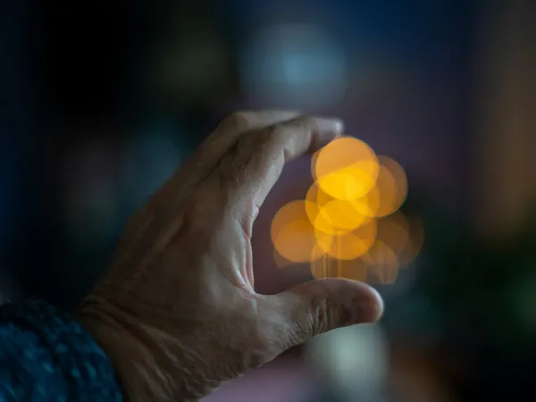 A blurry photo of a person holding a cell phone